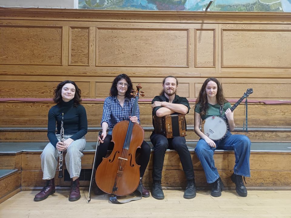 Four folk musicians: Eloise, Maya, Aaron, and Mia.